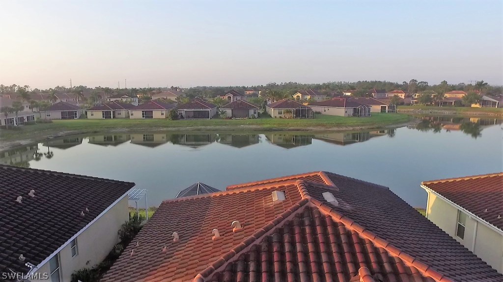 11674 Eros Road Lehigh Acres, FL 33971 - Photo 30 of 35 a view of a roof with wooden floor and lake view