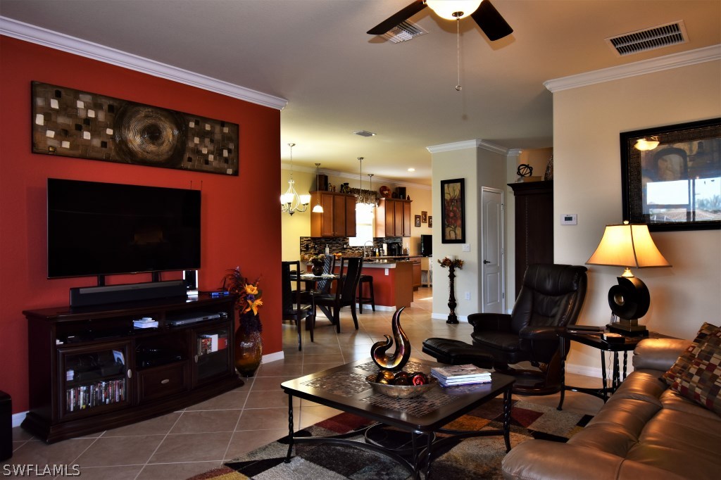 11674 Eros Road Lehigh Acres, FL 33971 - Photo 3 of 35 a living room with furniture and a flat screen tv