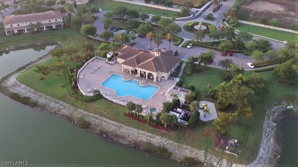 11674 Eros Road Lehigh Acres, FL 33971 - Photo 33 of 35 an aerial view of a house with a lake view