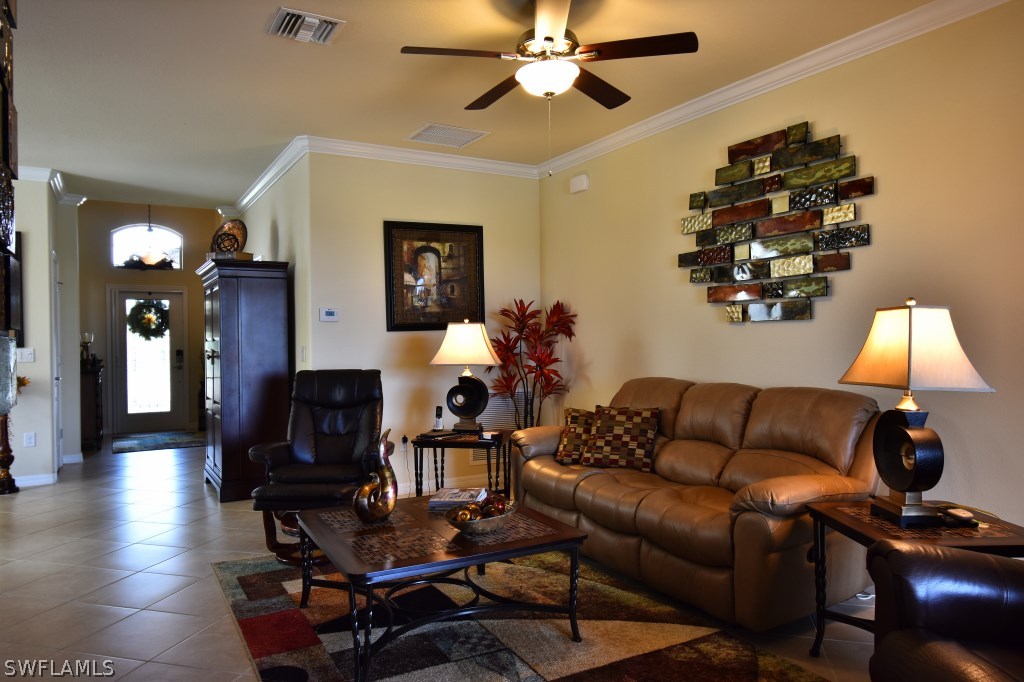 11674 Eros Road Lehigh Acres, FL 33971 - Photo 4 of 35 a living room with furniture and wooden floor