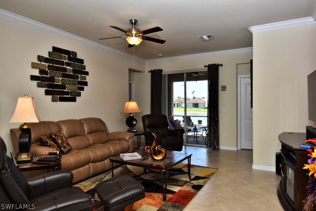 11674 Eros Road Lehigh Acres, FL 33971 - Photo 5 of 35 a living room with furniture a ceiling fan and a window