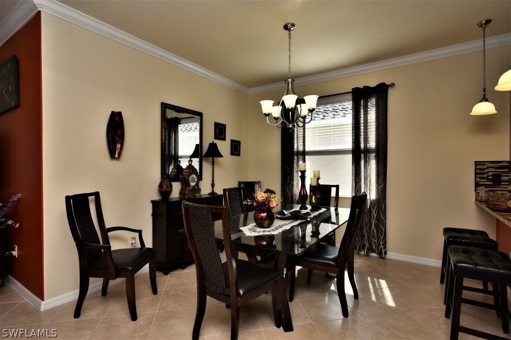 11674 Eros Road Lehigh Acres, FL 33971 - Photo 6 of 35 a view of a dining room with furniture and chandelier