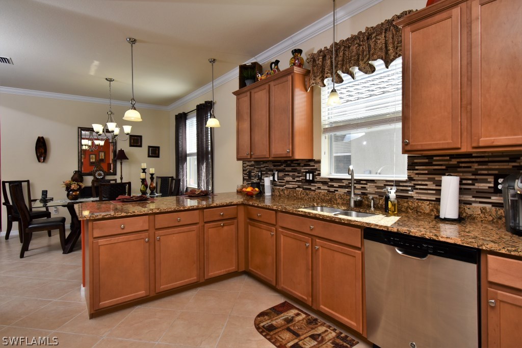 11674 Eros Road Lehigh Acres, FL 33971 - Photo 10 of 35 a kitchen with lots of counter space and a sink