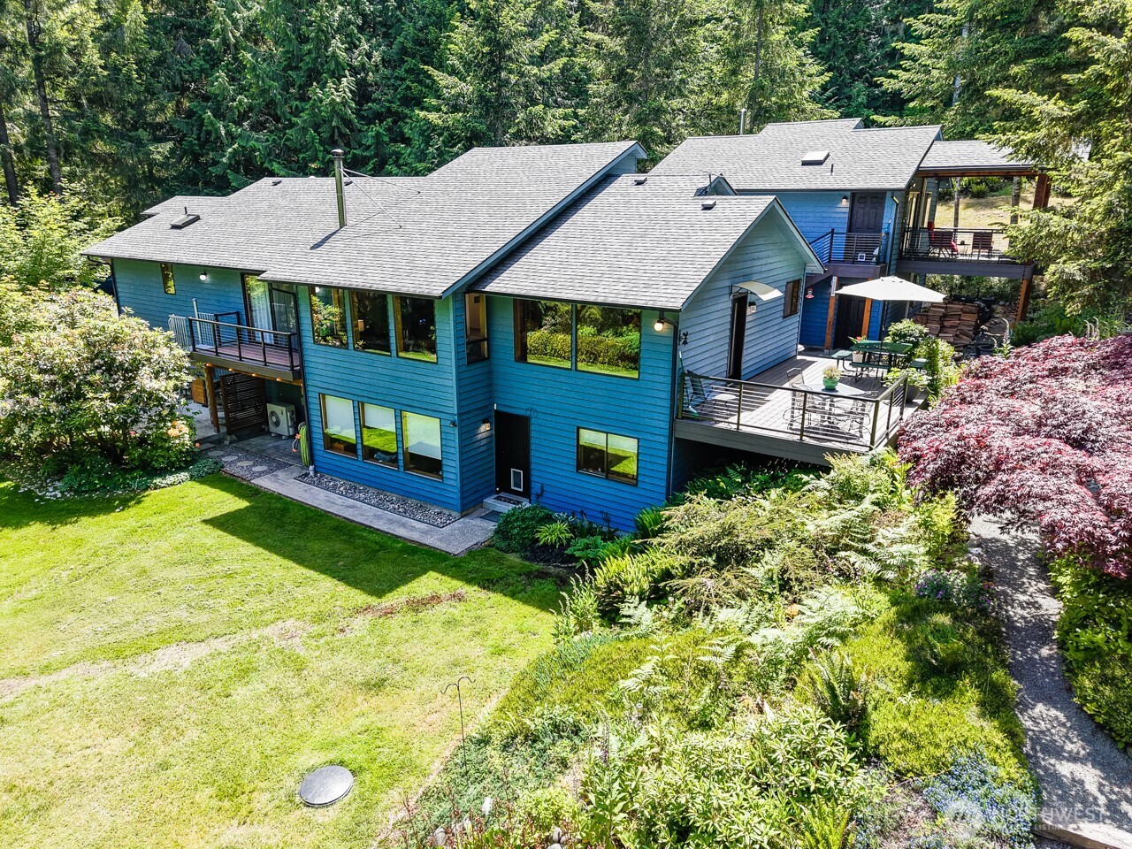 492 Walkabout Way Port Angeles, WA 98363 - Photo 1 of 40 a aerial view of a house with swimming pool and large trees