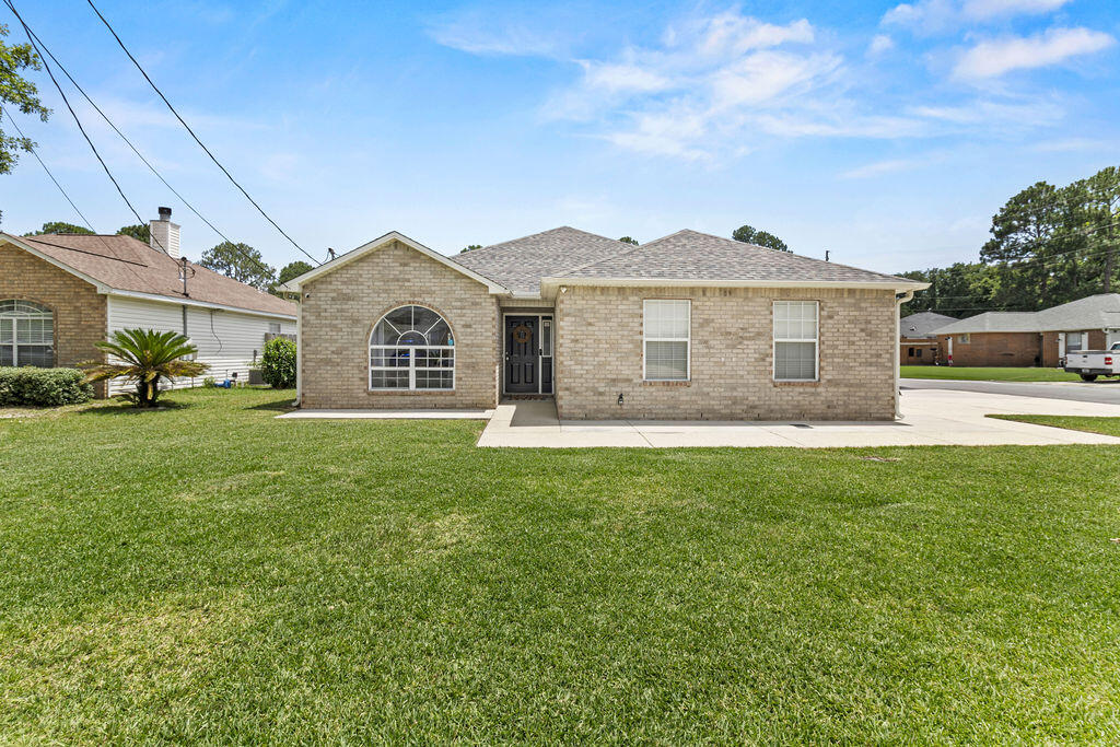 1791 Old Ranch Road Fort Walton Beach, FL 32547 - Photo 1 of 30 a front view of a house with a garden and yard