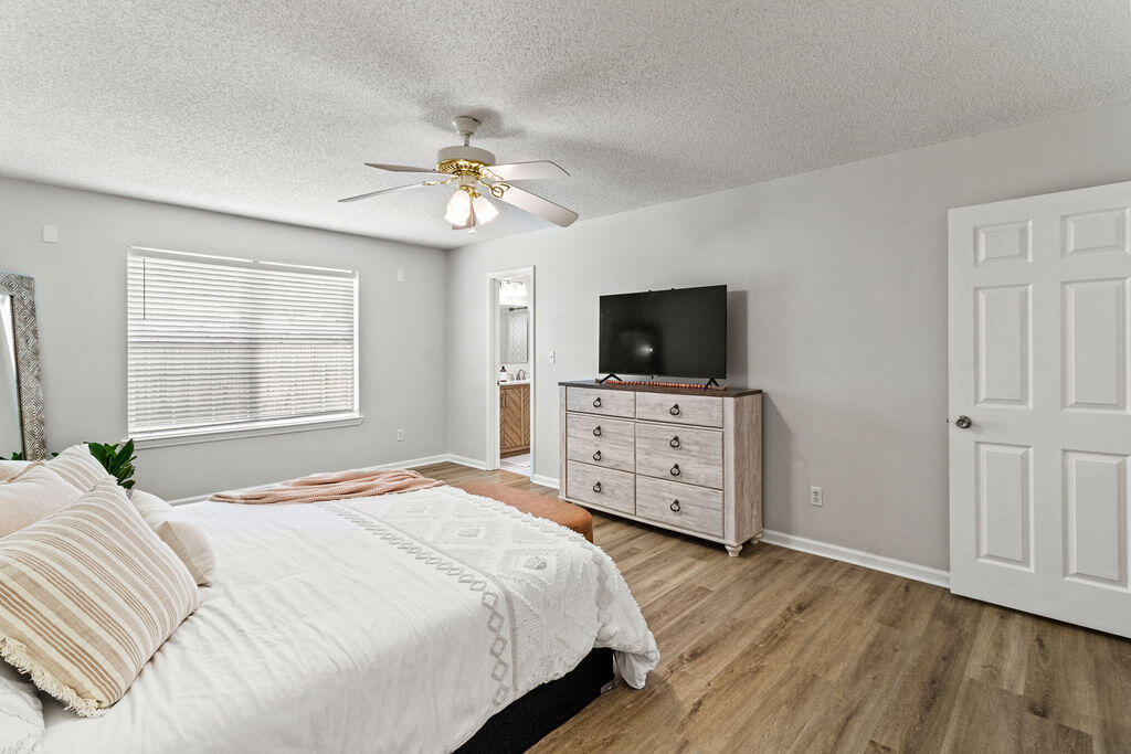 1791 Old Ranch Road Fort Walton Beach, FL 32547 - Photo 17 of 30 a bedroom with a bed and a flat tv screen on dresser