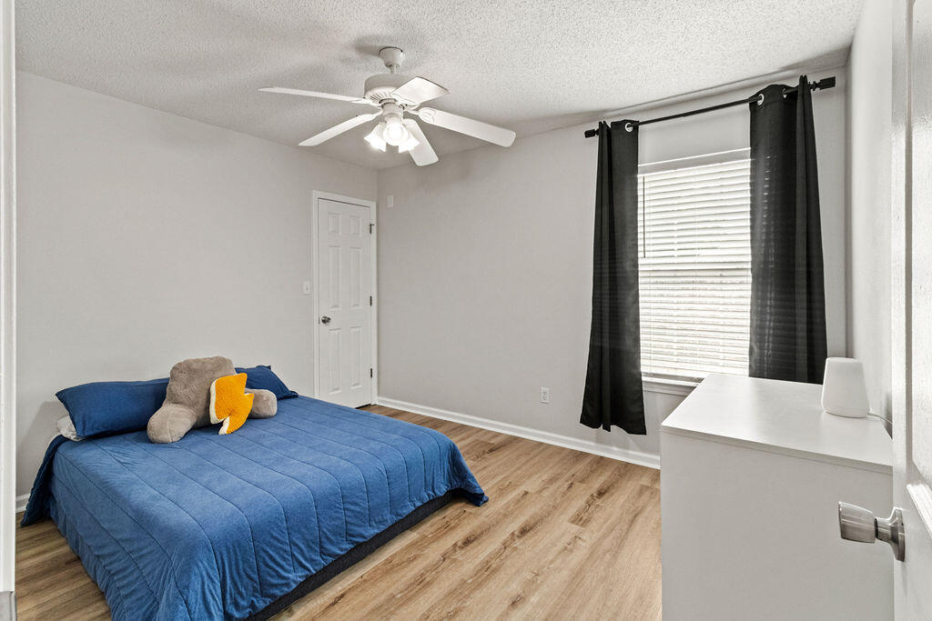 1791 Old Ranch Road Fort Walton Beach, FL 32547 - Photo 19 of 30 a bedroom with a bed and wooden floor