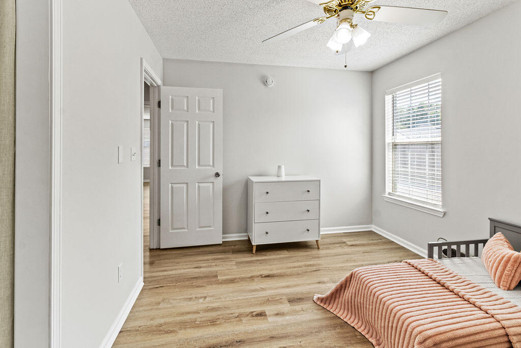 1791 Old Ranch Road Fort Walton Beach, FL 32547 - Photo 22 of 30 a bedroom with a bed and a chandelier