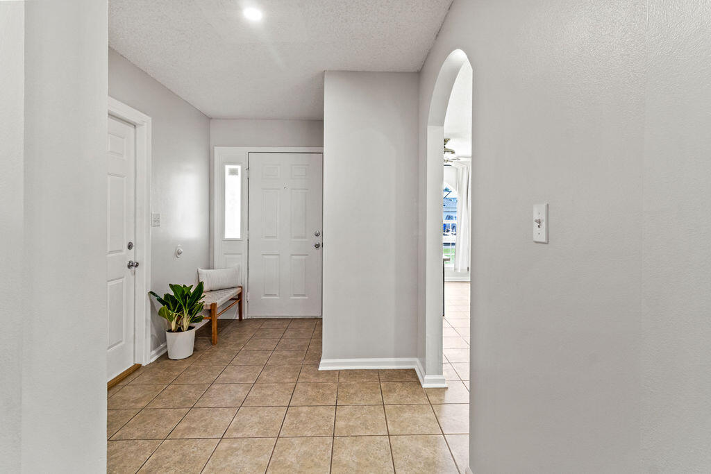 1791 Old Ranch Road Fort Walton Beach, FL 32547 - Photo 5 of 30 a view of a hallway with closet and a potted plant