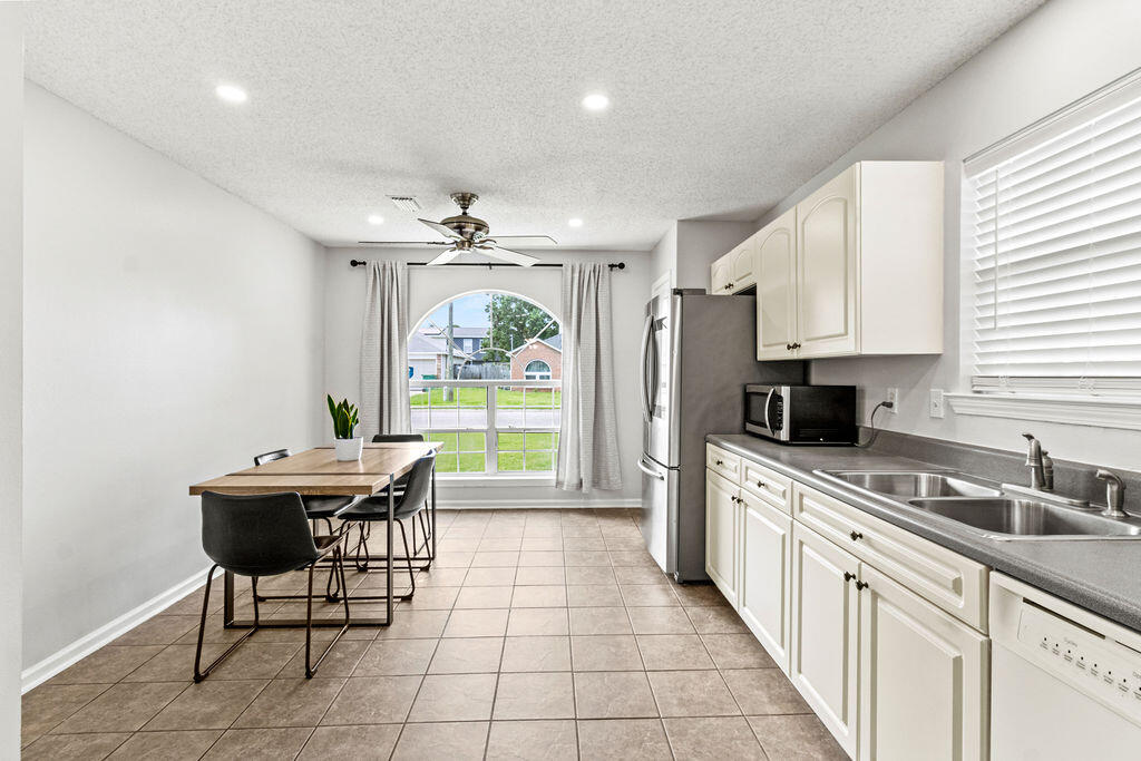 1791 Old Ranch Road Fort Walton Beach, FL 32547 - Photo 7 of 30 a kitchen with stainless steel appliances kitchen island granite countertop a sink and cabinets