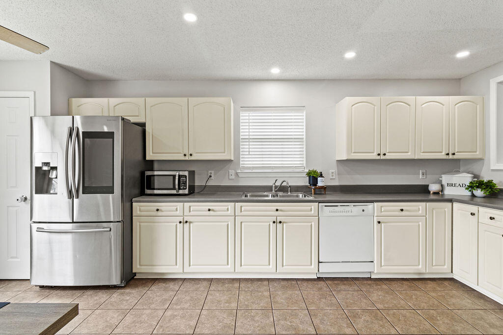 1791 Old Ranch Road Fort Walton Beach, FL 32547 - Photo 8 of 30 a kitchen with white cabinets stainless steel appliances and a sink