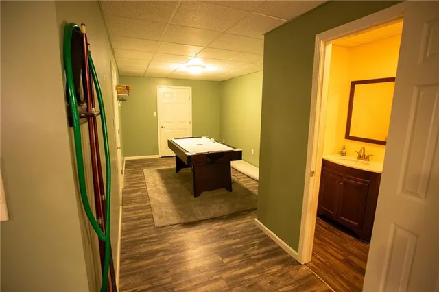 a view of a hallway with wooden floor and furniture