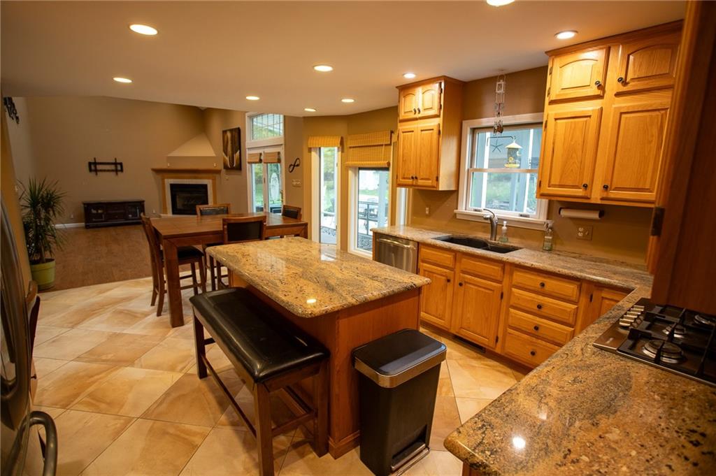 357 Morningstar Lane Neshannock, PA 16105 - Photo 6 of 25 a kitchen with stainless steel appliances granite countertop a stove a sink dishwasher and a refrigerator with wooden floor