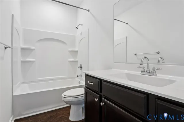 a bathroom with a granite countertop sink toilet a large mirror and shower