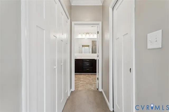 a view of a hallway with wooden floor and entryway