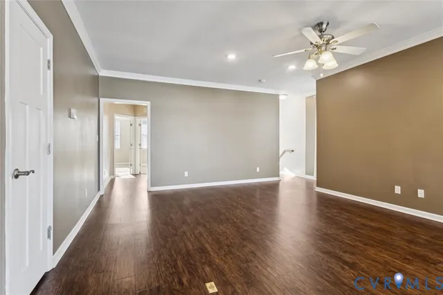 a view of an empty room with wooden floor