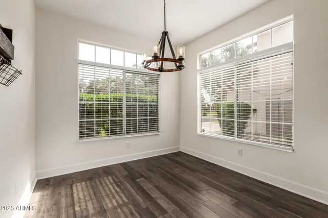 a view of wooden floor and windows in a room