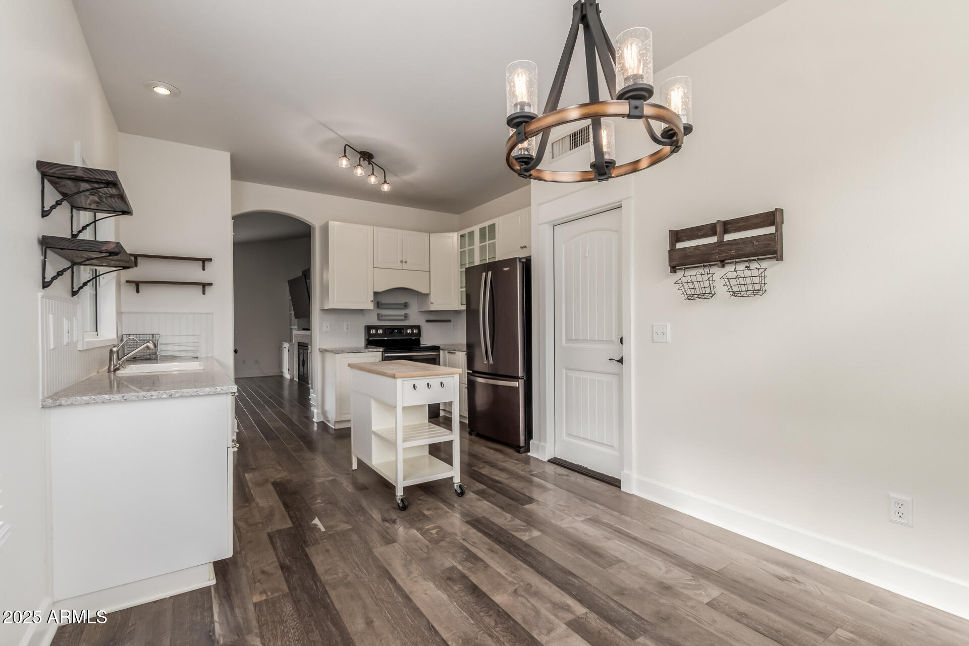 1132 North Hudson Place Chandler, AZ 85225 - Photo 12 of 34 a kitchen with stainless steel appliances a refrigerator a sink dishwasher a stove and white cabinets with wooden floor