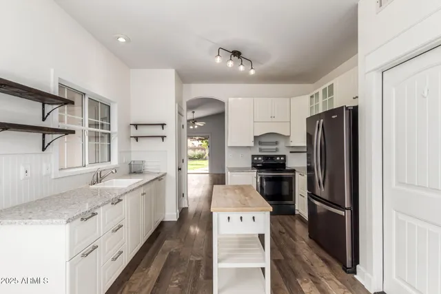 a kitchen with a refrigerator and a sink