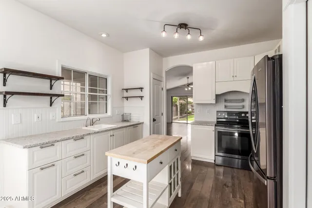 a kitchen with a stove sink and refrigerator