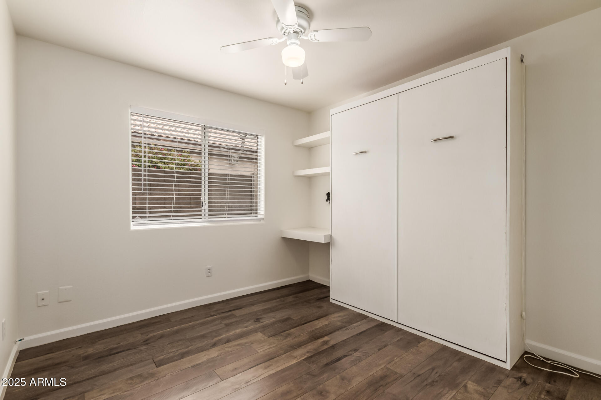 1132 North Hudson Place Chandler, AZ 85225 - Photo 21 of 34 a view of an empty room with wooden floor and a window