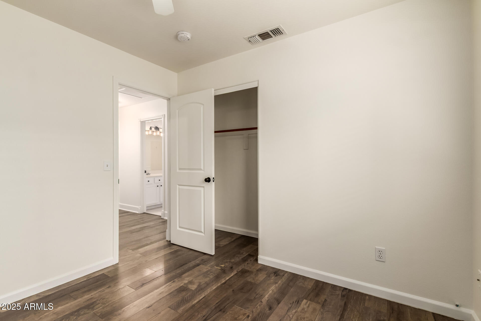 1132 North Hudson Place Chandler, AZ 85225 - Photo 22 of 34 a view of an empty room with wooden floor and closet