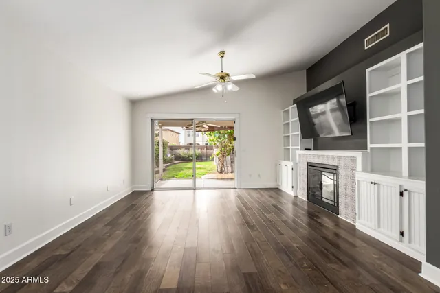 wooden floor in an empty room with a fireplace