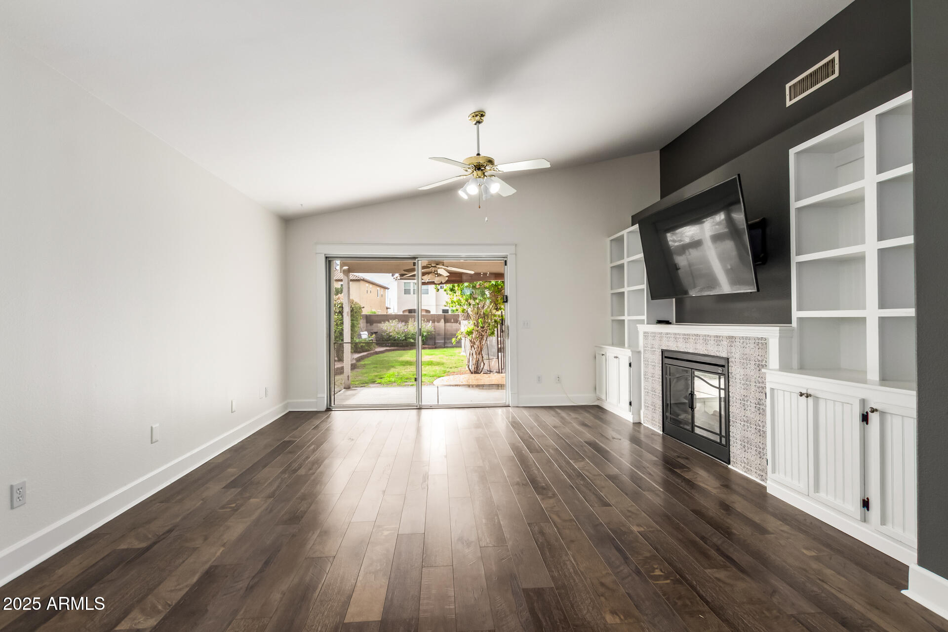 1132 North Hudson Place Chandler, AZ 85225 - Photo 8 of 34 wooden floor in an empty room with a fireplace