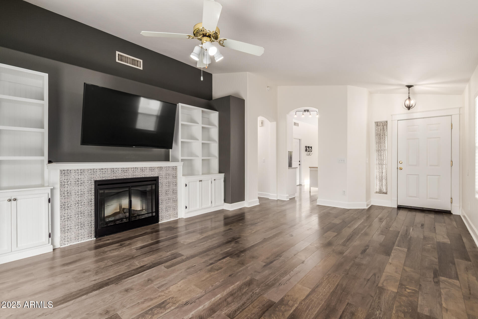 1132 North Hudson Place Chandler, AZ 85225 - Photo 10 of 34 a view of an empty room with wooden floor fireplace and a window