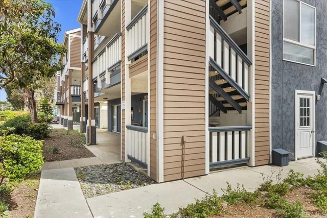 a view of a house with a window and wooden fence