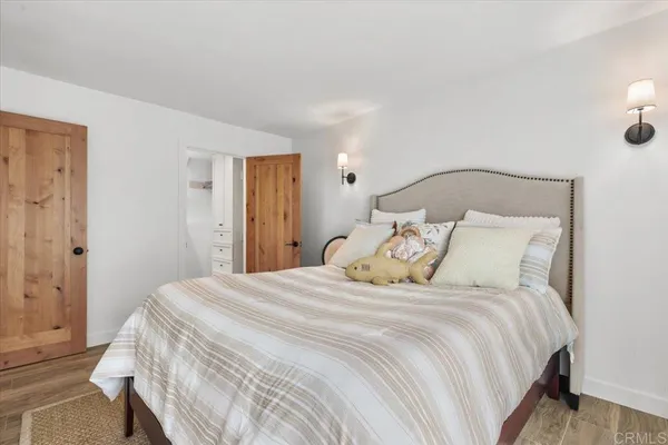 a bedroom with a bed and a mirror