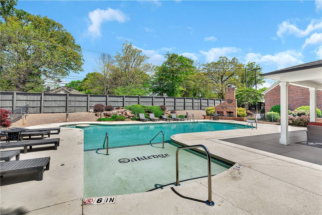 209 Calhoun Street Clemson, SC 29631 - Photo 22 of 25 An inviting swimming pool area sits surrounded by a concrete deck and privacy fencing.