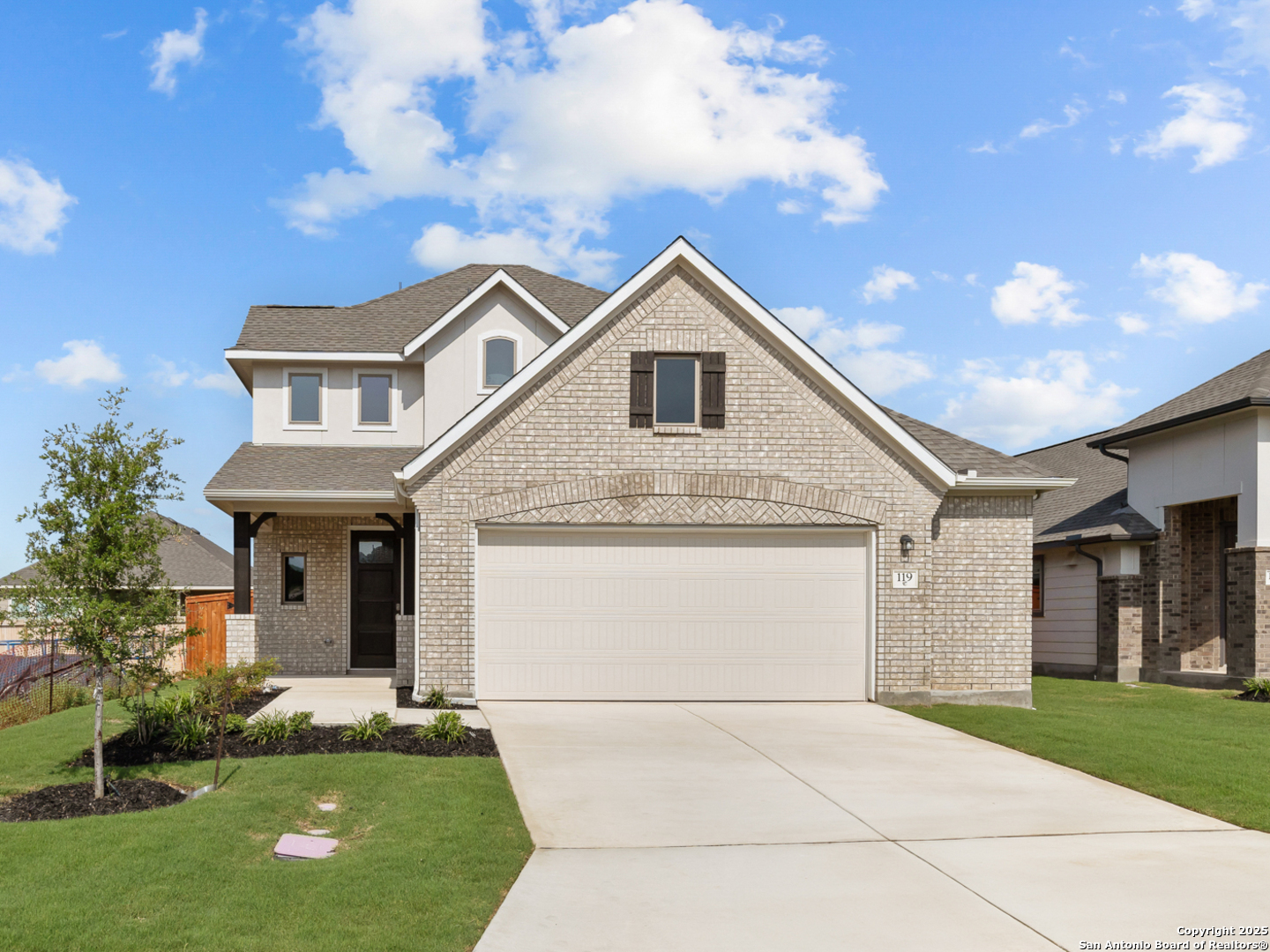 a front view of a house with a yard and garage