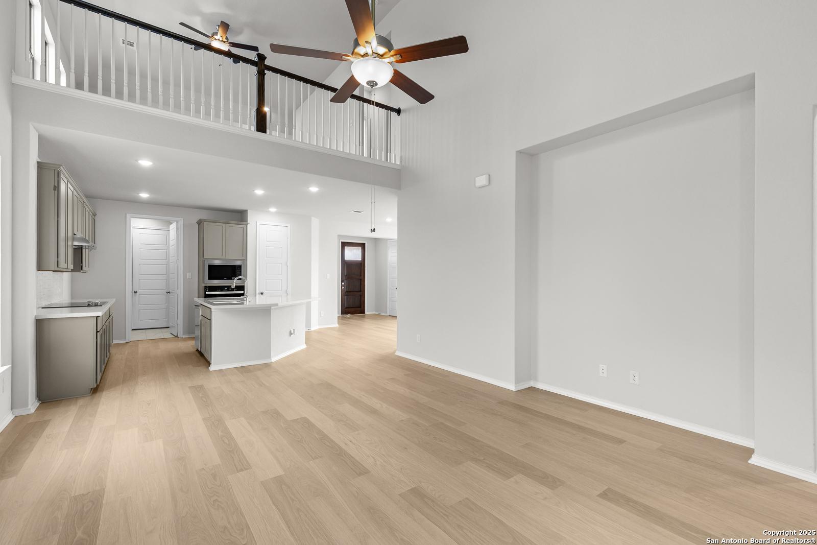 119 Mallorys Way Castroville, TX 78009 - Photo 13 of 24 a view of a kitchen with a sink and refrigerator