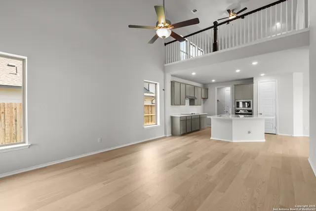 a view of large kitchen with a sink stainless steel appliances and cabinets