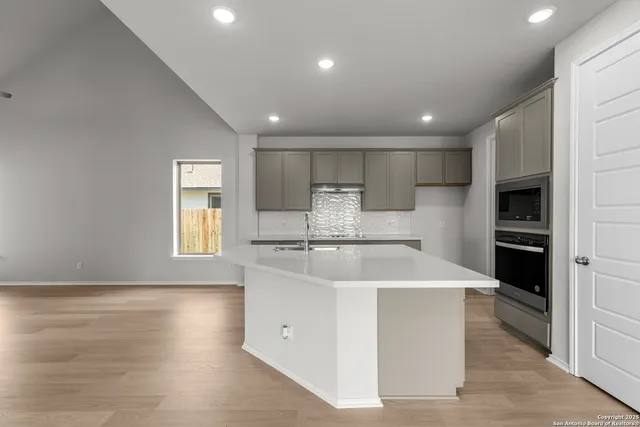 a kitchen with stainless steel appliances a refrigerator sink and cabinets