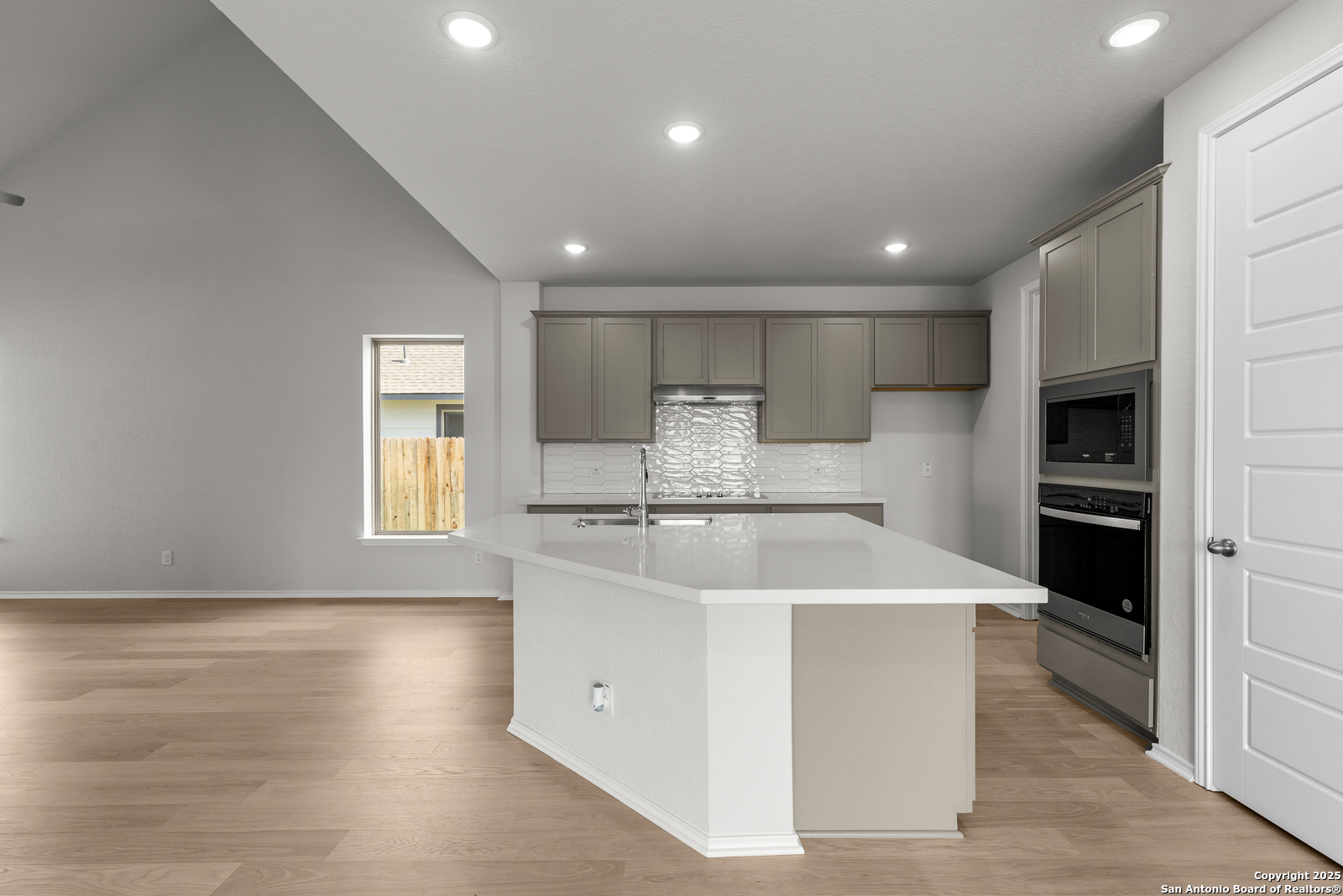 119 Mallorys Way Castroville, TX 78009 - Photo 18 of 24 a kitchen with stainless steel appliances a refrigerator sink and cabinets