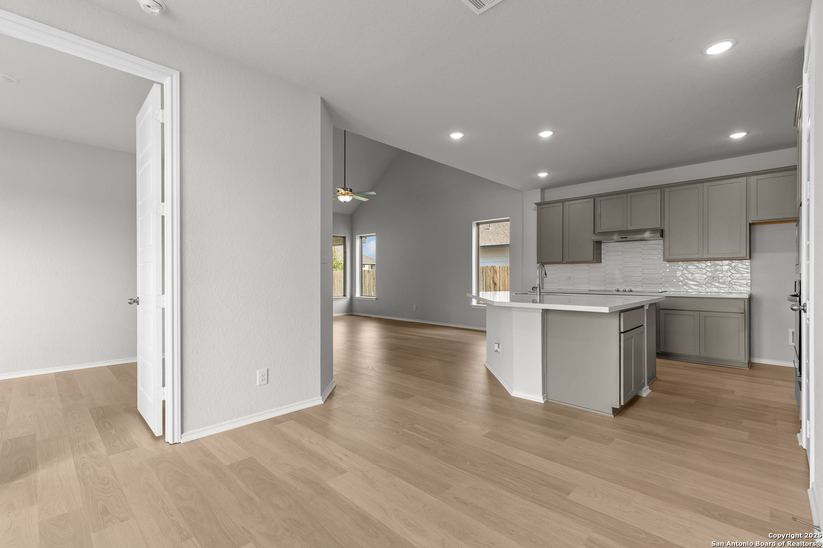 119 Mallorys Way Castroville, TX 78009 - Photo 19 of 24 a kitchen with a refrigerator sink and cabinets
