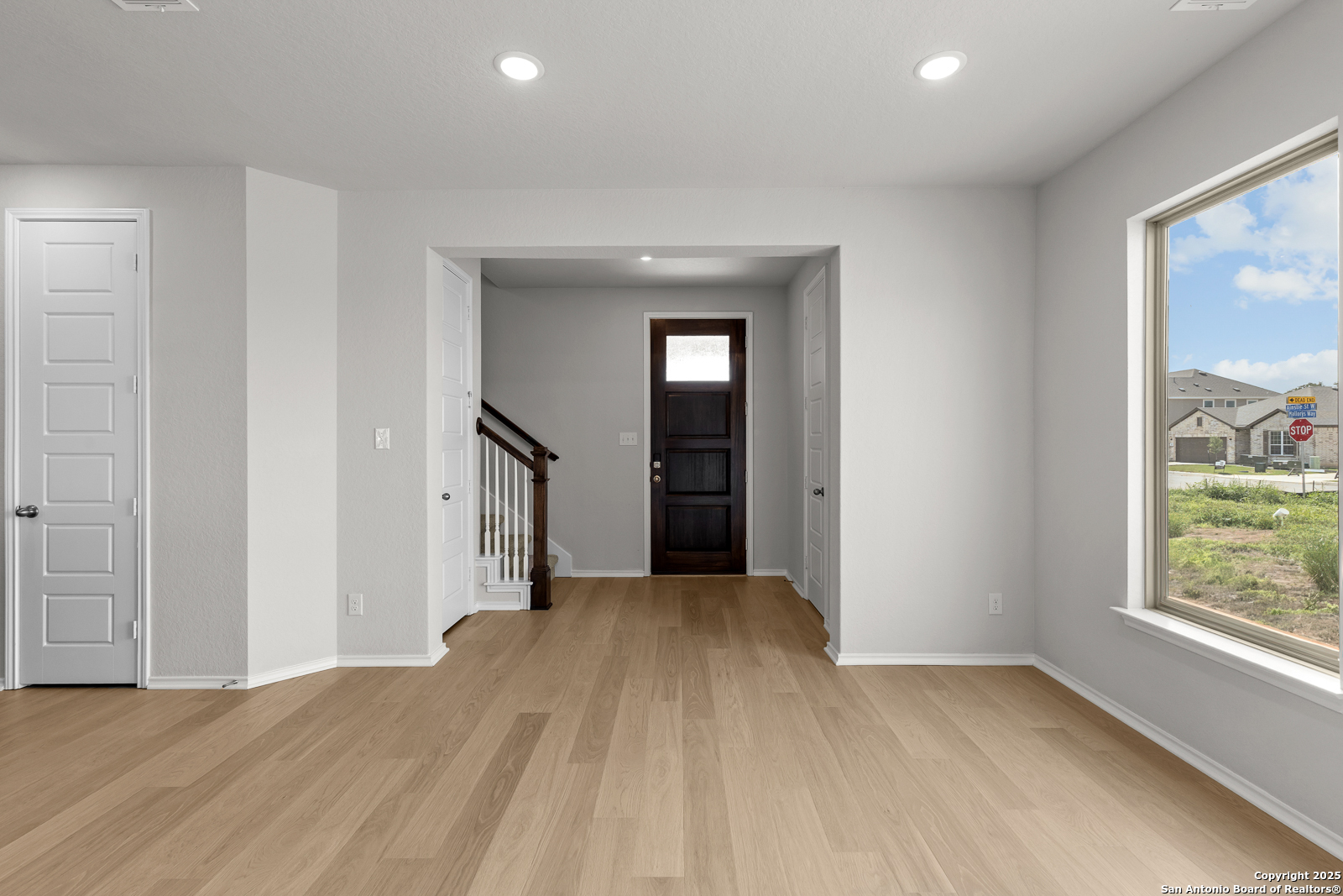 119 Mallorys Way Castroville, TX 78009 - Photo 20 of 24 a view of hallway with a large window and wooden floor