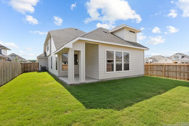 a view of a house with backyard and porch