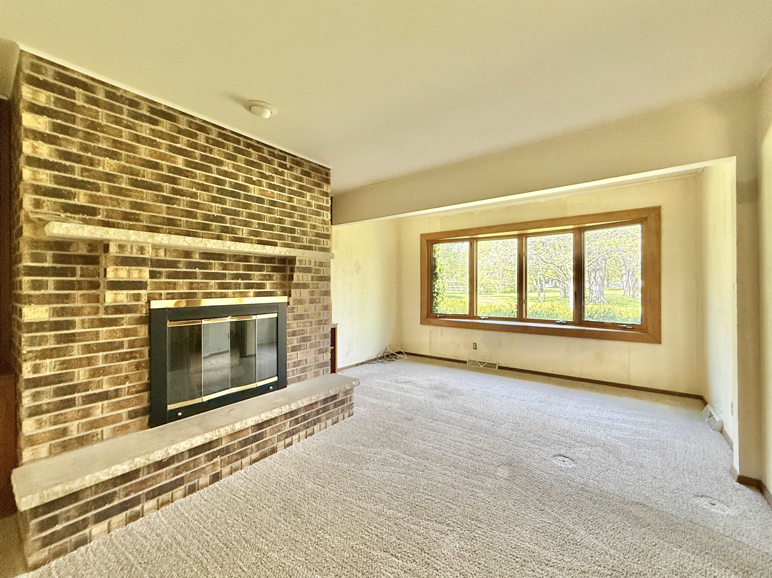 3620 Valerie Road Roscoe, IL 61073 - Photo 9 of 26 a view of an empty room with a fireplace and a window