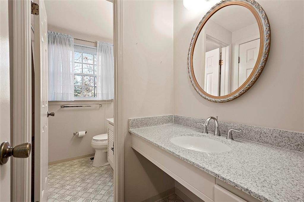 1619 Tiffany Ridge Drive Pittsburgh, PA 15241 - Photo 18 of 25 a bathroom with a granite countertop toilet a sink and a mirror