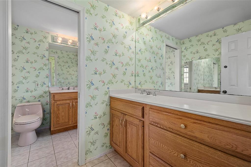 1619 Tiffany Ridge Drive Pittsburgh, PA 15241 - Photo 21 of 25 a bathroom with a granite countertop sink a toilet and a mirror