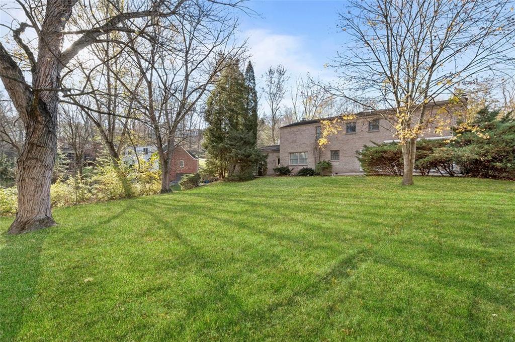 1619 Tiffany Ridge Drive Pittsburgh, PA 15241 - Photo 24 of 25 a view of a yard with a house in the background