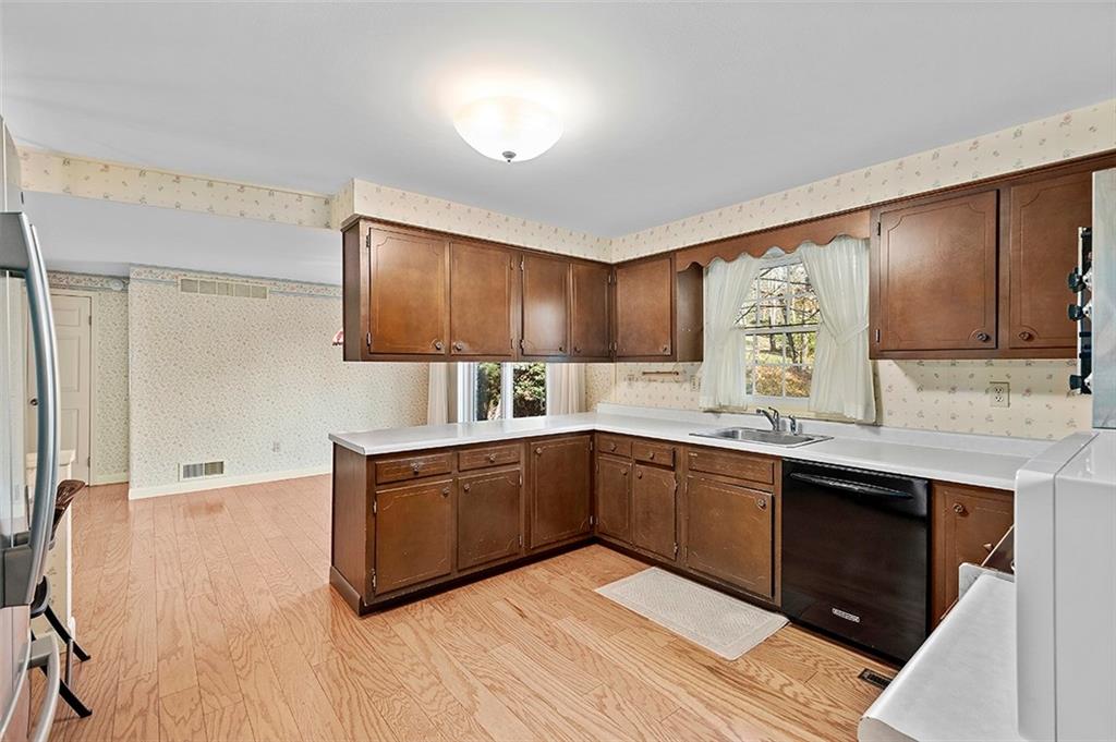 1619 Tiffany Ridge Drive Pittsburgh, PA 15241 - Photo 8 of 25 a kitchen with stainless steel appliances granite countertop a sink and cabinets