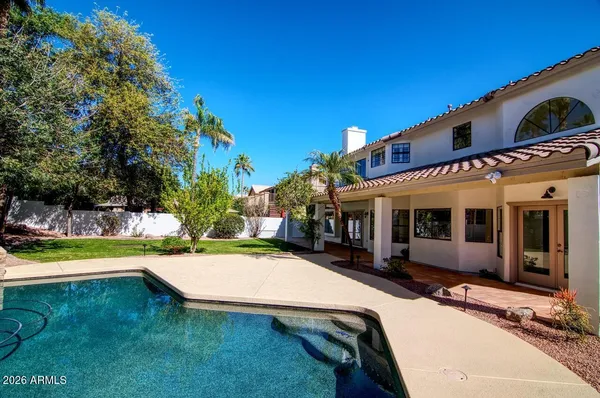a view of a house with swimming pool and sitting area
