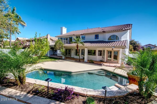 a front view of a house with a garden