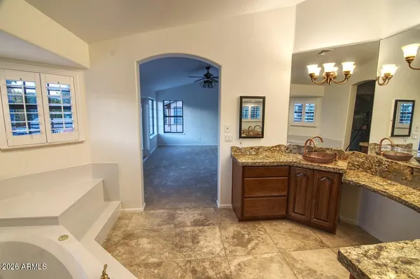 a bathroom with a sink a vanity and a mirror