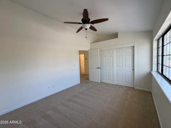a view of empty room with ceiling fan