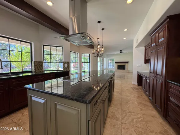 a kitchen with stainless steel appliances granite countertop a sink a oven and a refrigerator